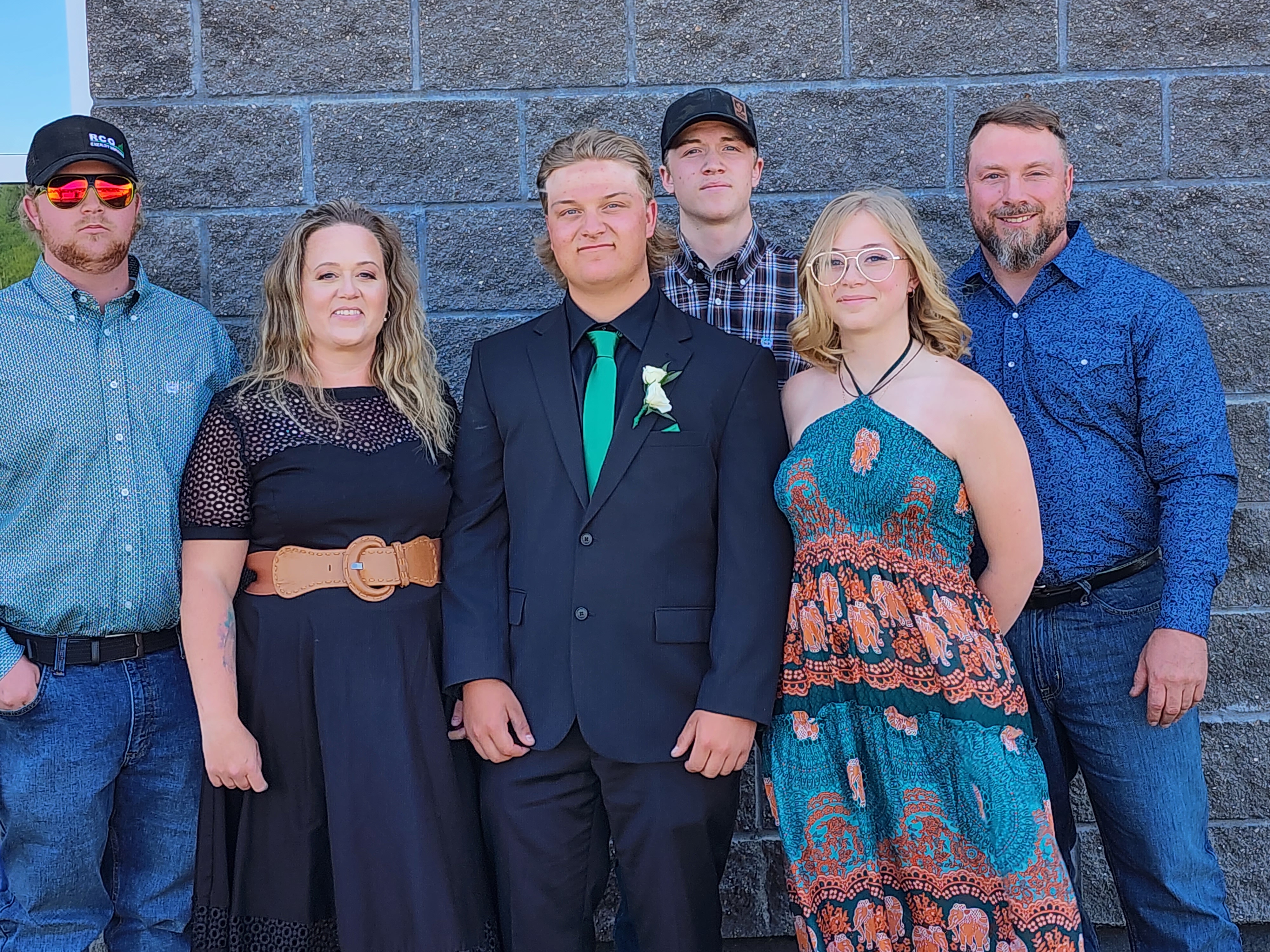 Heidi and her family smiling with a turquoise border